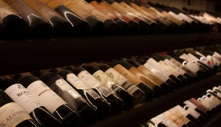 black and white bottles on brown wooden shelf